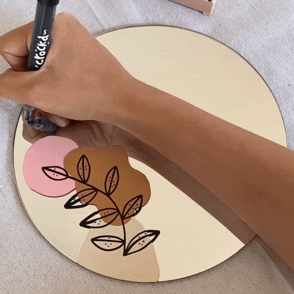 Paint marker craft demonstration on a mirror