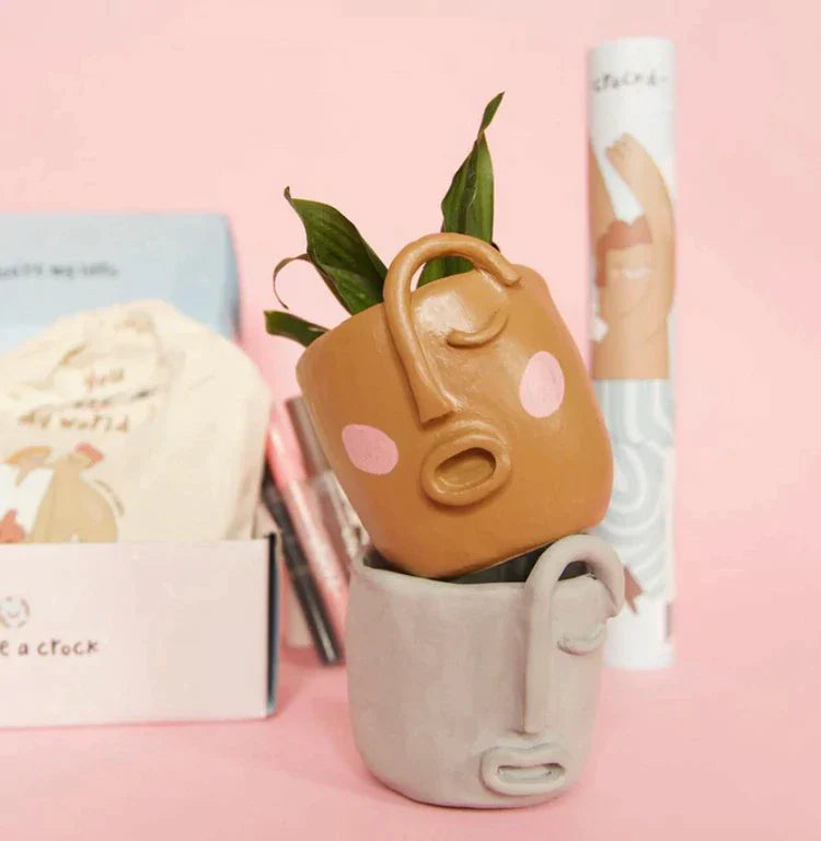 Signature crockd clay mugs that are air dried and painted