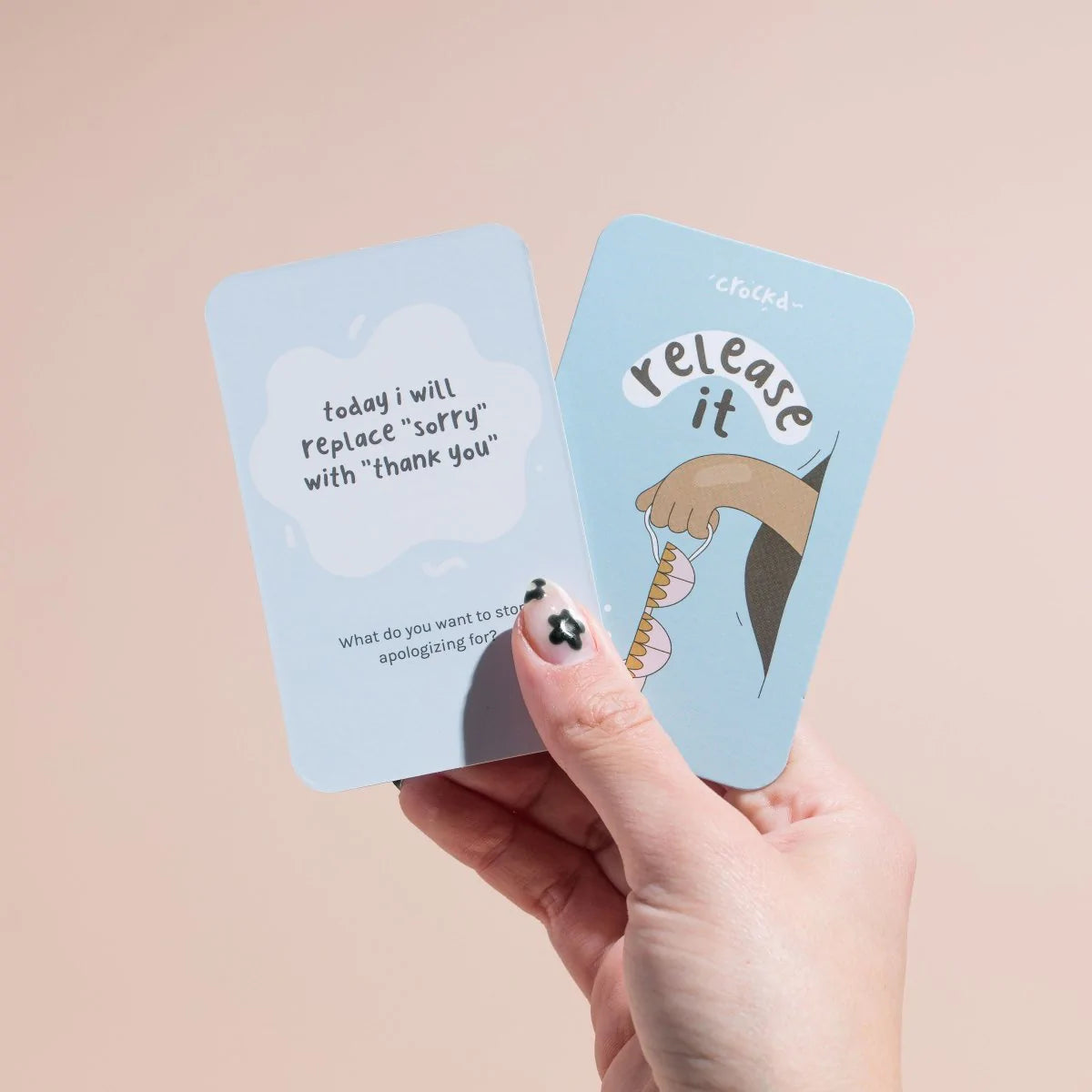 Hand holding up a ‘release it’ card by crockd