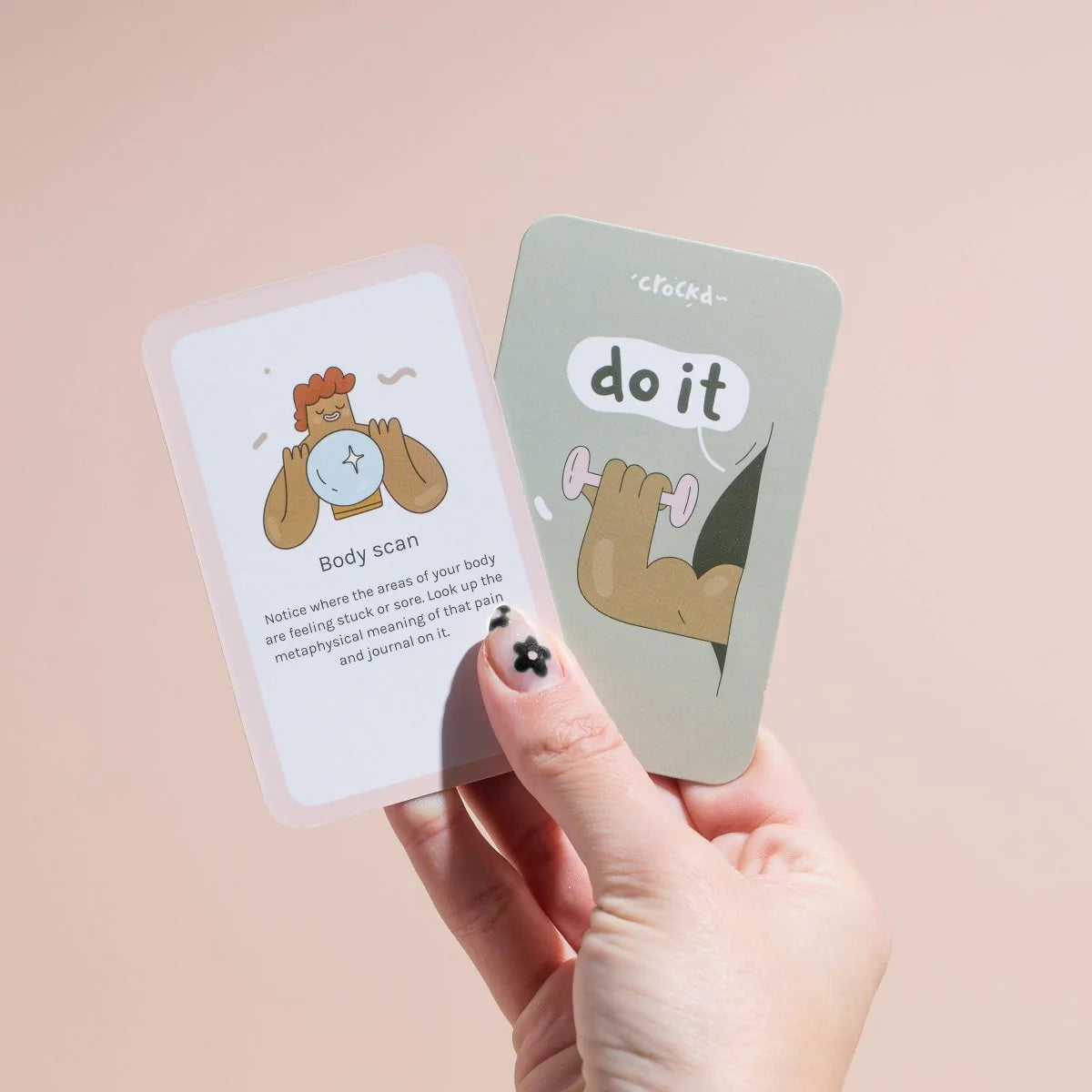 Hand holding up a ‘do it’ card by crockd
