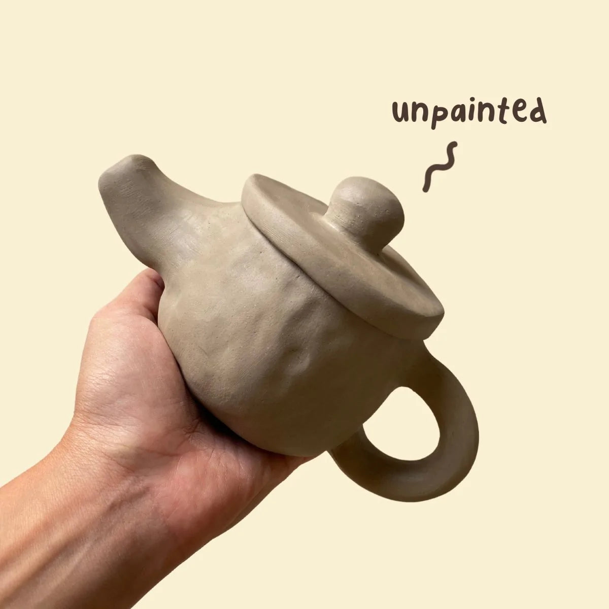 A finished and unpainted clay tea cup ready for firing and glazing